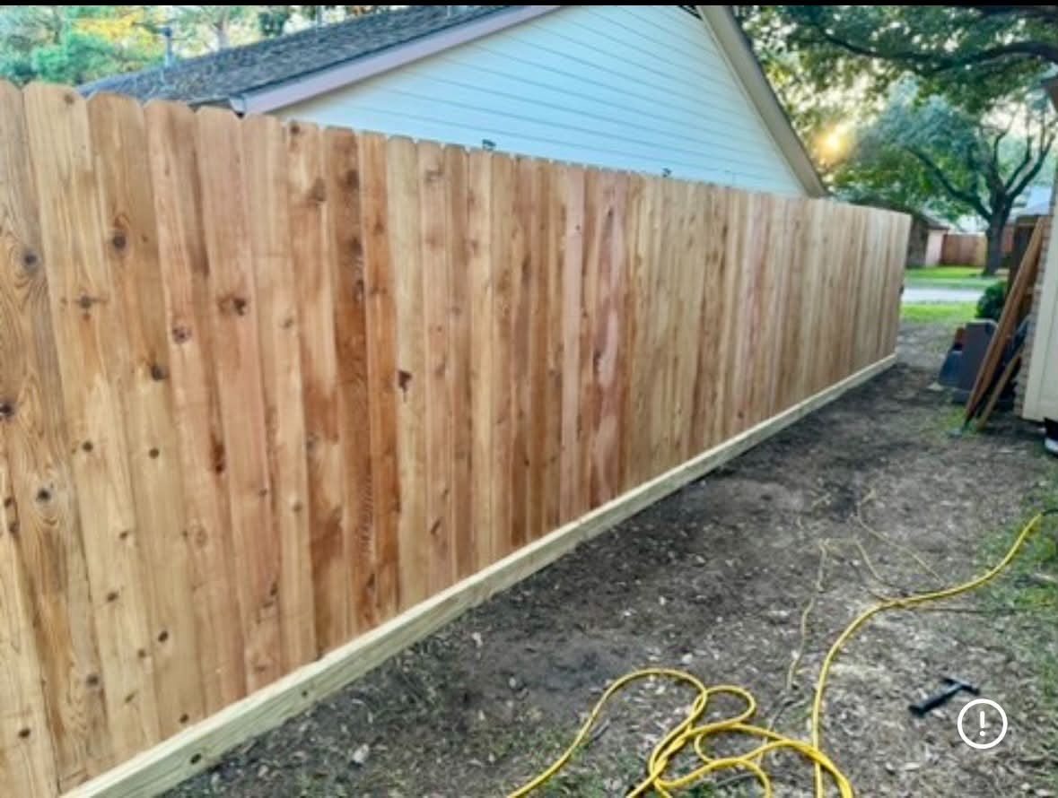 New cedar privacy fence running along a side yard